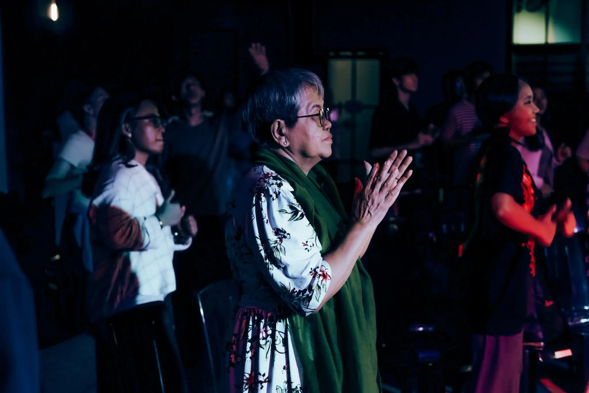 A church member worshipping with lifted hands