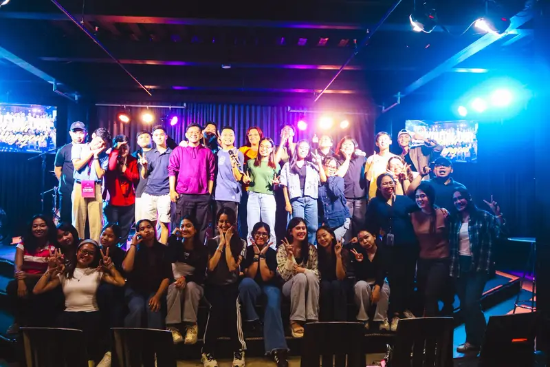 The congregation gathered in front of the stage under blue and purple lights
