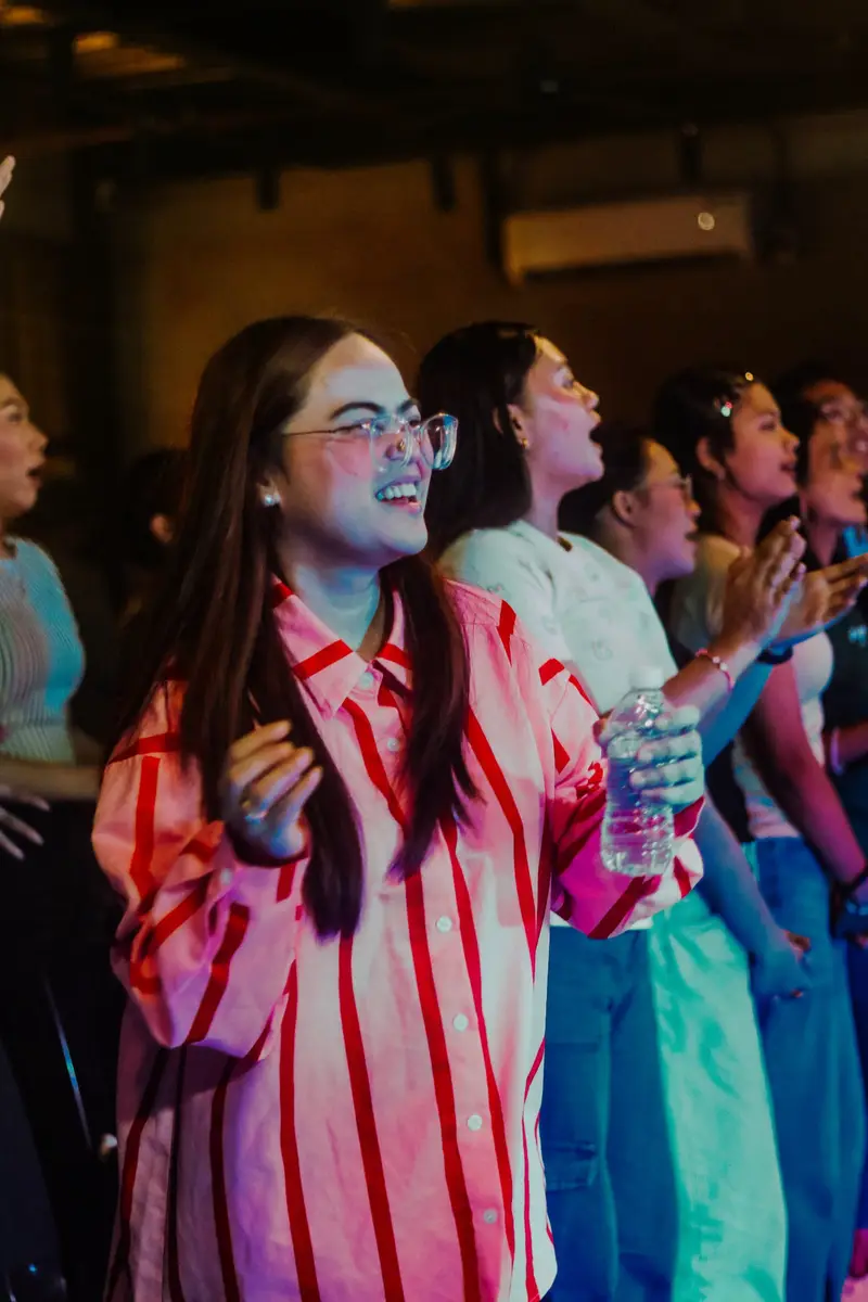 Young women singing joyfully during worship