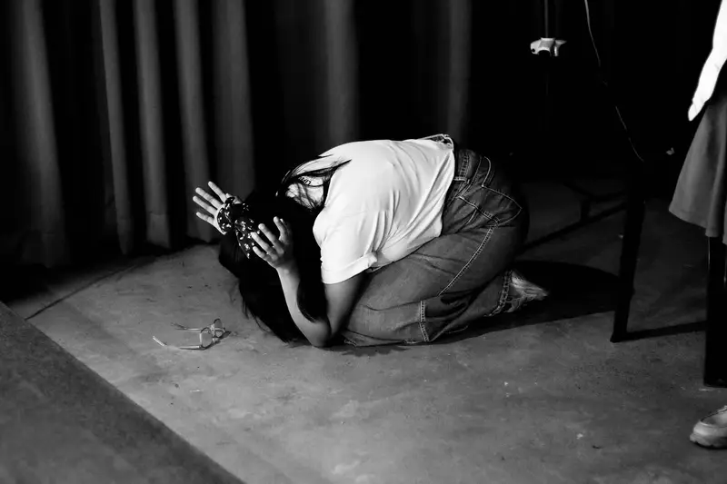 A man kneeling in prayer, in black and white
